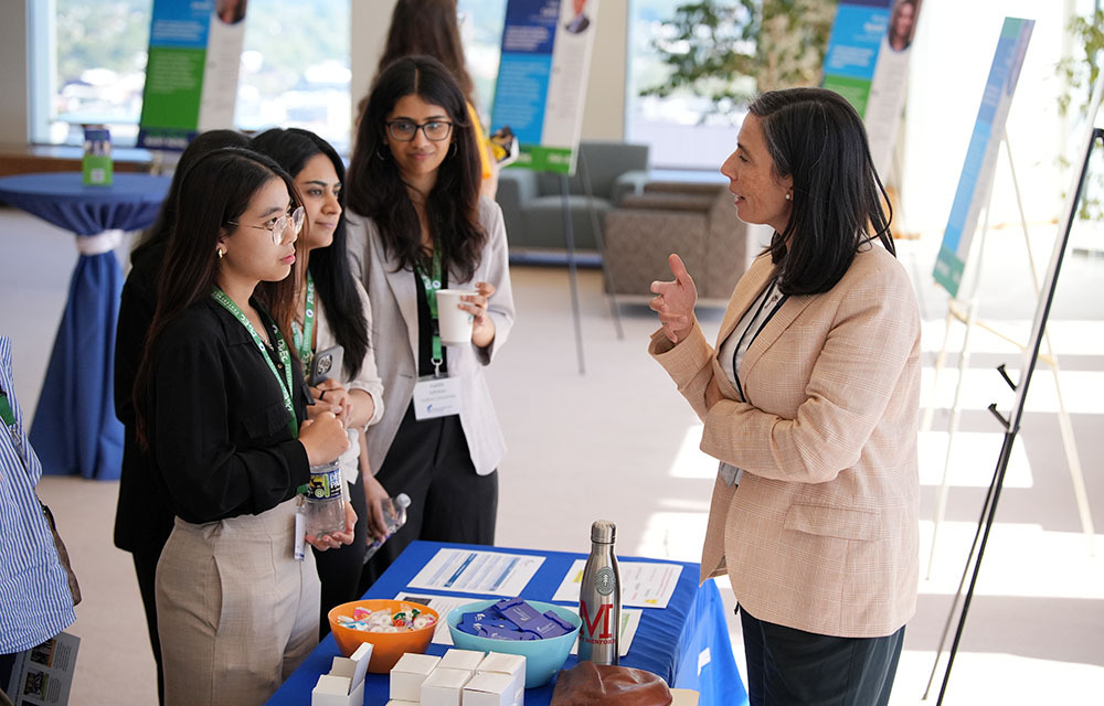Economists talking at a table at an event